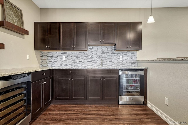 kitchen with beverage cooler, dark wood-style flooring, and dark brown cabinetry