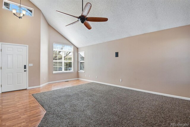 12535 Forest View St, Broomfield, CO 80020 - interior space featuring light wood-style floors, baseboards, high vaulted ceiling, a textured ceiling, and ceiling fan with notable chandelier