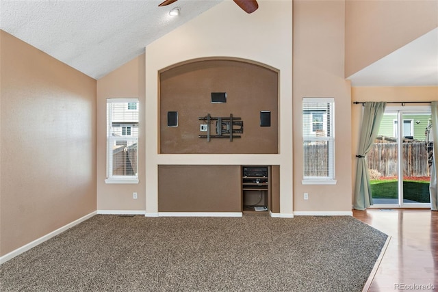 12535 Forest View St, Broomfield, CO 80020 - unfurnished living room featuring a textured ceiling, ceiling fan, baseboards, and high vaulted ceiling