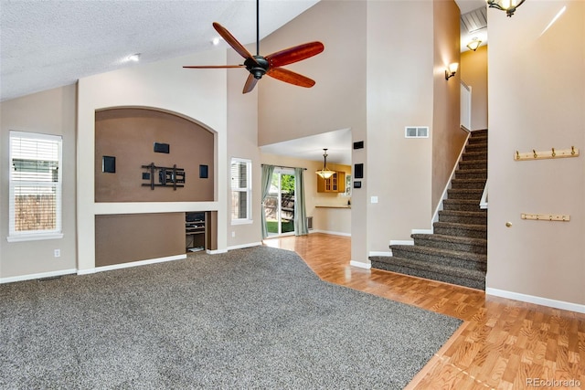 12535 Forest View St, Broomfield, CO 80020 - unfurnished living room featuring visible vents, stairs, wood finished floors, baseboards, and ceiling fan