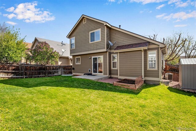 12535 Forest View St, Broomfield, CO 80020 - back of property with a fenced backyard, a yard, a patio area, and central AC