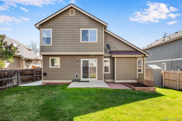 12535 Forest View St, Broomfield, CO 80020 - back of house with a fenced backyard, a lawn, a patio area, and a storage shed