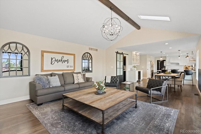 living area featuring a barn door, a chandelier, baseboards, dark wood-type flooring, and visible vents