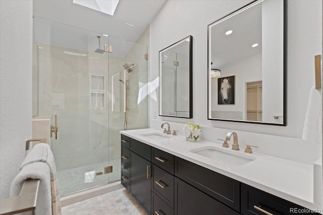 bathroom with a sink, a stall shower, recessed lighting, and double vanity