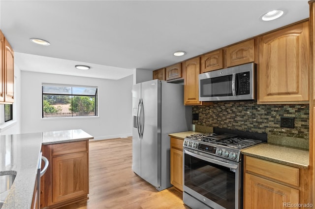 3871 E Euclid Ave, Centennial, CO 80121 - kitchen with stainless steel appliances, backsplash, light wood finished floors, recessed lighting, and light stone counters
