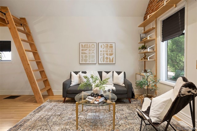 sitting room featuring visible vents, baseboards, and wood finished floors