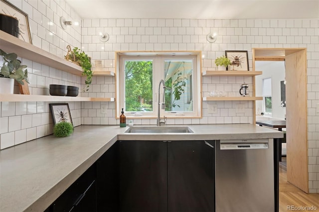 kitchen featuring dishwasher, backsplash, light countertops, open shelves, and a sink