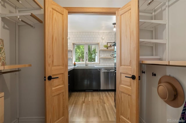 interior space with light wood-style flooring and a sink