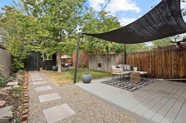 view of patio featuring a deck, outdoor lounge area, and a fenced backyard