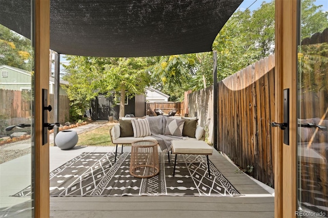 wooden terrace with a fenced backyard