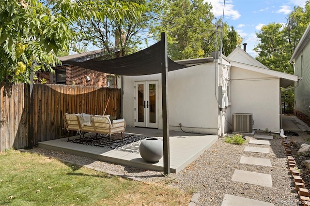 rear view of house with a patio, cooling unit, fence, french doors, and stucco siding