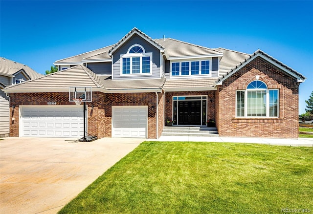 view of front of home with a front yard and a garage