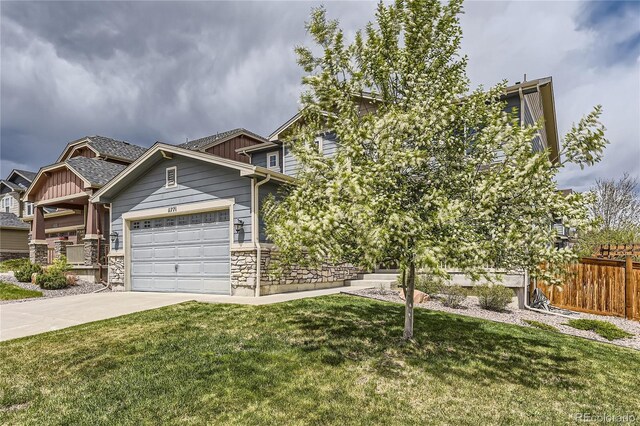 craftsman-style house with a front lawn, board and batten siding, fence, and driveway