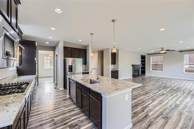 11771 W Quarles Ave, Littleton, CO 80127 - kitchen featuring a sink, appliances with stainless steel finishes, wood finished floors, baseboards, and recessed lighting