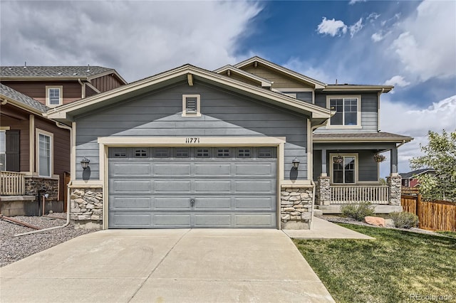 11771 W Quarles Ave, Littleton, CO 80127 - craftsman-style home featuring stone siding, concrete driveway, an attached garage, and covered porch