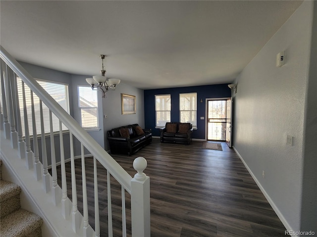 living room with a notable chandelier and dark hardwood / wood-style floors