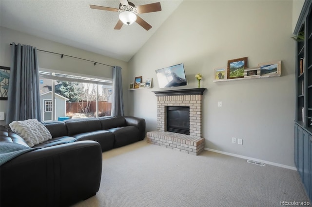 living room featuring a ceiling fan, a textured ceiling, carpet flooring, baseboards, and a brick fireplace