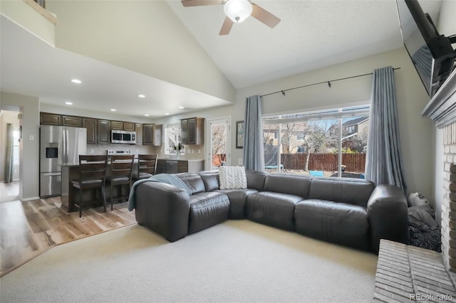 living room featuring recessed lighting, high vaulted ceiling, light wood-type flooring, and ceiling fan