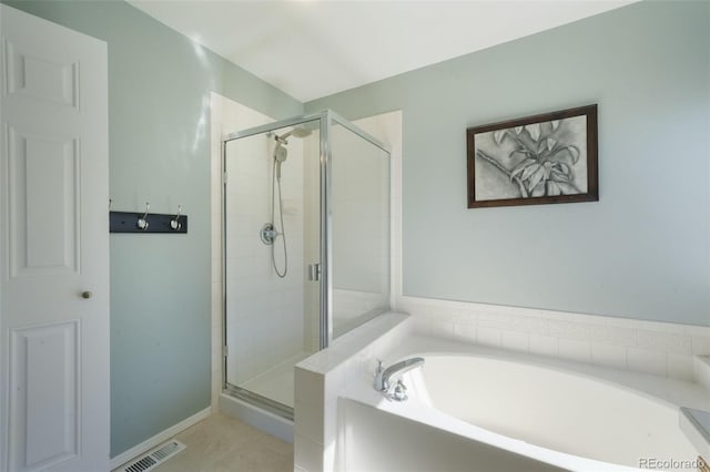 full bathroom featuring visible vents, a garden tub, and a stall shower