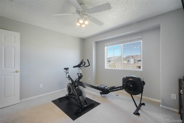 workout room with baseboards, carpet flooring, a textured ceiling, and a ceiling fan