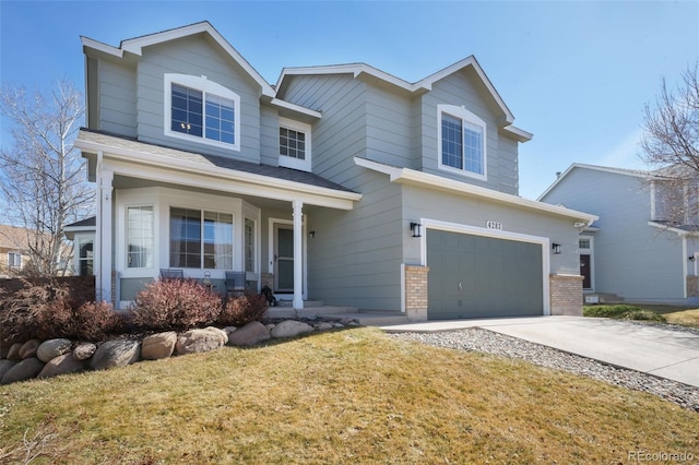 view of front of home featuring a porch, concrete driveway, a garage, and a front yard