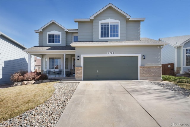 view of front of house with a porch, an attached garage, brick siding, and concrete driveway