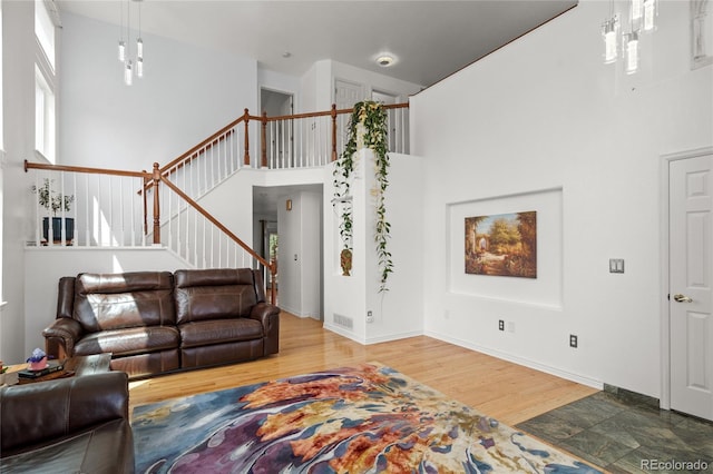 408 Sylvestor Trl, Highlands Ranch, CO 80129 - living room with a high ceiling, stairway, and wood finished floors