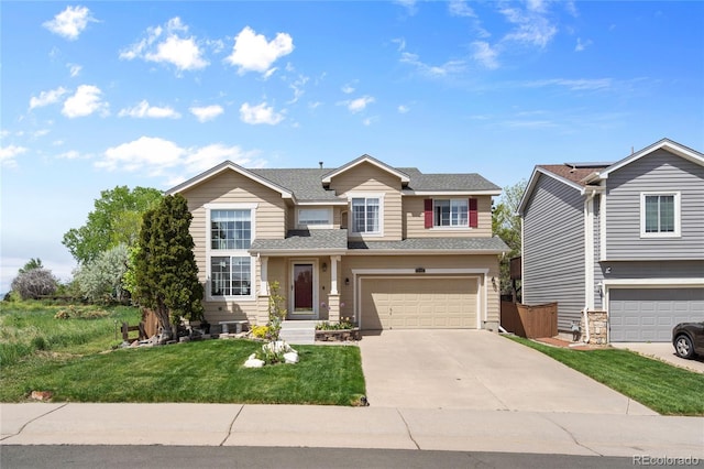 408 Sylvestor Trl, Highlands Ranch, CO 80129 - view of front of house featuring an attached garage, concrete driveway, a front lawn, and a shingled roof