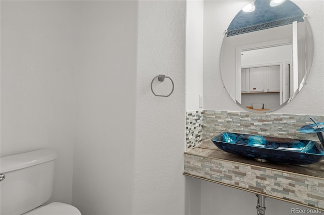 408 Sylvestor Trl, Highlands Ranch, CO 80129 - half bathroom with a sink and decorative backsplash