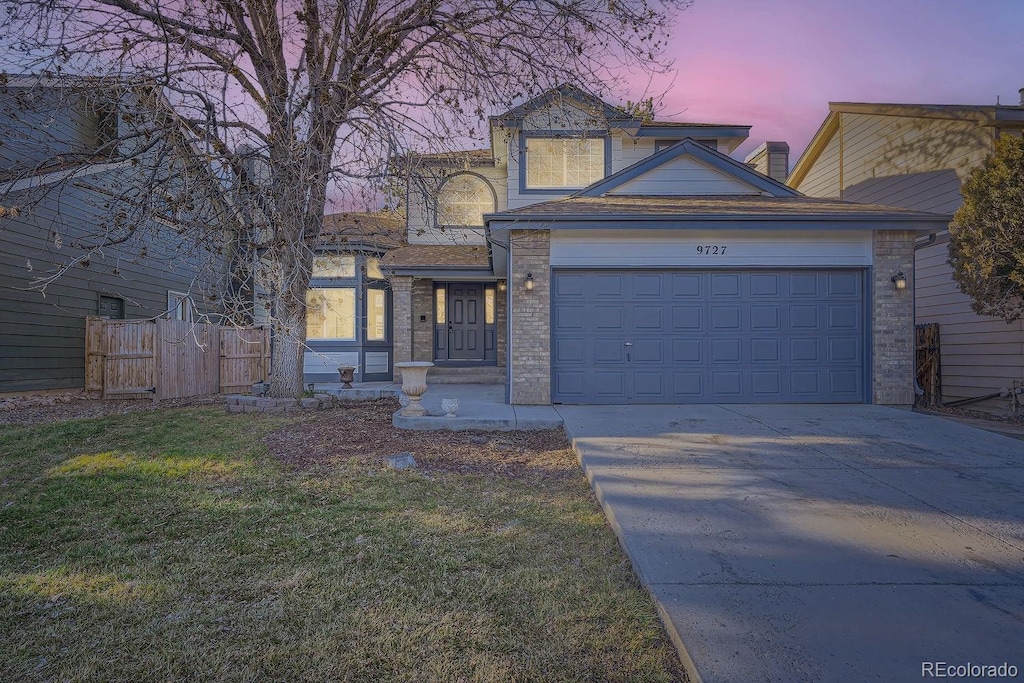 view of front of house with a lawn and a garage