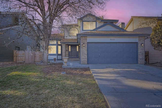 view of front of house with a lawn and a garage