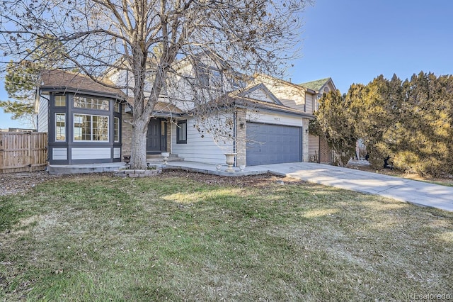 view of front of property featuring a front yard and a garage