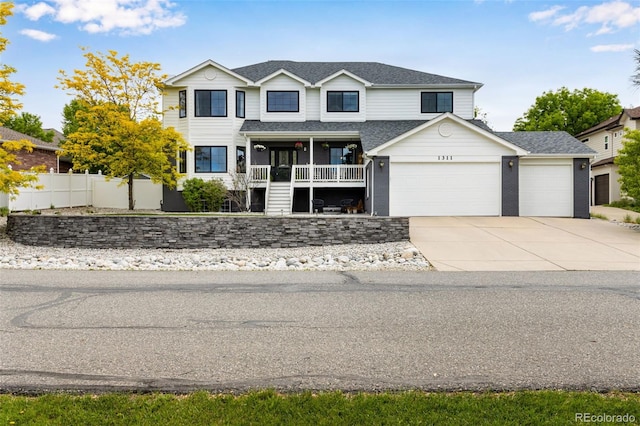 1311 Fletcher Dr, Erie, CO 80516 - view of front facade featuring an attached garage, concrete driveway, covered porch, and a shingled roof