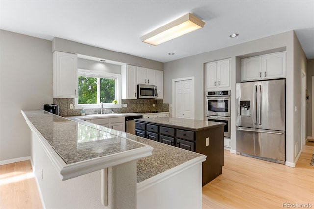 1311 Fletcher Dr, Erie, CO 80516 - kitchen featuring stainless steel appliances, white cabinetry, a sink, and recessed lighting