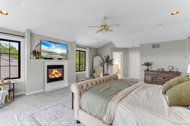 1311 Fletcher Dr, Erie, CO 80516 - bedroom with light colored carpet, baseboards, a glass covered fireplace, lofted ceiling, and ensuite bathroom