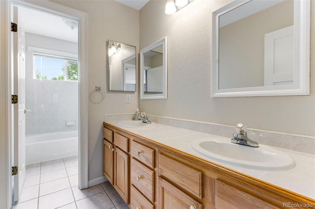 1311 Fletcher Dr, Erie, CO 80516 - full bath with double vanity, tile patterned floors, a tub, and baseboards