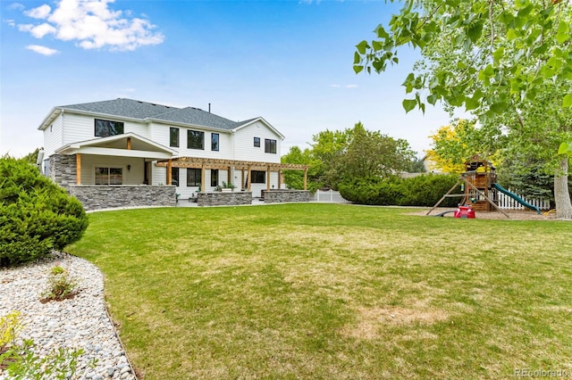 1311 Fletcher Dr, Erie, CO 80516 - back of property with a playground and stone siding