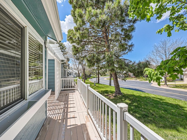 wooden deck with a lawn
