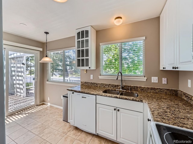 kitchen featuring white appliances, a sink, white cabinetry, glass insert cabinets, and light tile patterned flooring