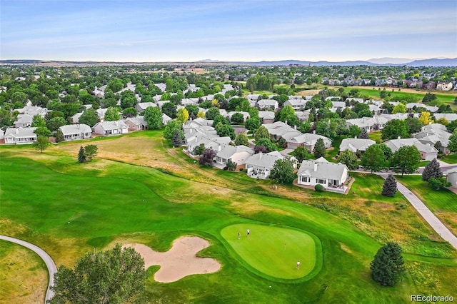 aerial perspective of suburban area with a mountain backdrop and a golf course