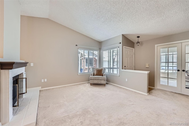 living area with vaulted ceiling, light colored carpet, a textured ceiling, baseboards, and french doors