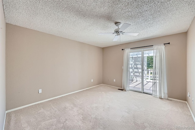 unfurnished room featuring ceiling fan, carpet flooring, baseboards, and a textured ceiling