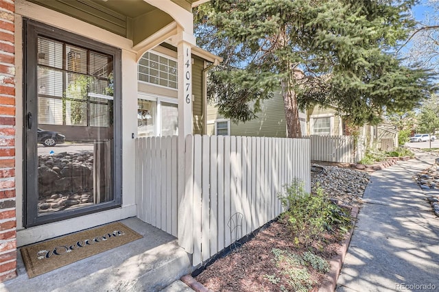 view of exterior entry with fence