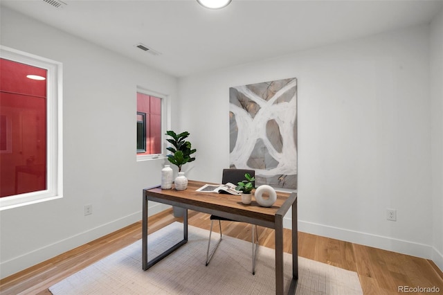 office area with baseboards and light wood-style floors