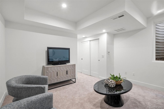 sitting room featuring carpet floors, baseboards, recessed lighting, and a tray ceiling