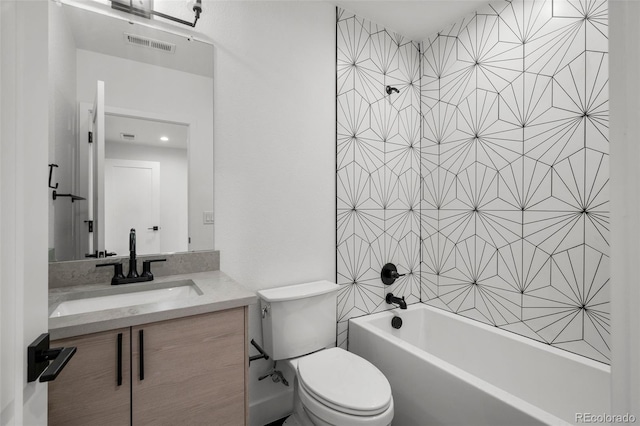 bathroom featuring toilet, bathtub / shower combination, and vanity
