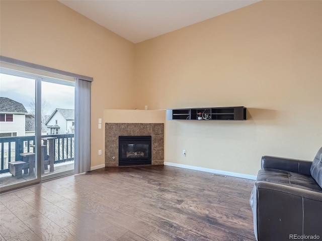 living room featuring a fireplace, a healthy amount of sunlight, and hardwood / wood-style flooring