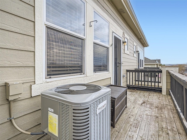 wooden balcony featuring central AC unit and a deck