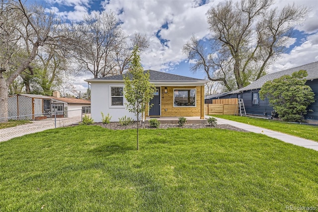 bungalow-style home featuring fence and a front yard