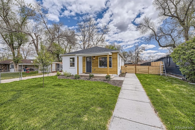 bungalow with fence, a porch, and a front lawn